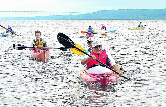 Kayakers paddle Saturday near Kingston Point Park to hail the Hudson's new honor, a National Water Trail designation. Leading are Paul, front, and Scott Keller. Scott's son, Nate, is at left.