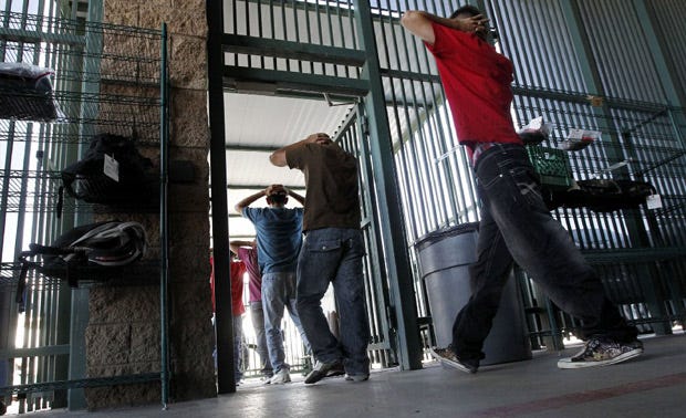 Illegal immigrants prepare to enter a bus after being processed at Tucson Sector U.S. Border Patrol Headquarters in Tucson, Arizona.