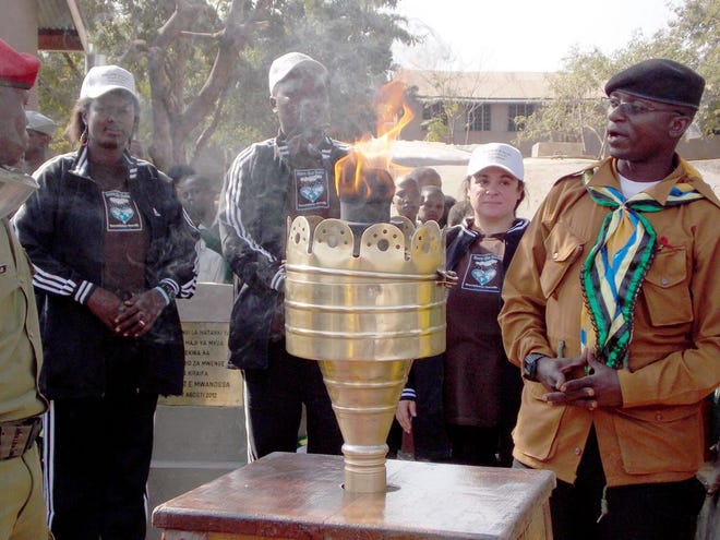 Mount Shasta’s Kelly Coleman, founder of Save the Rain, stands behind the Uhuru Torch, one of Tanzania’s national symbols of freedom and hope. Coleman has twice been selected to run with the torch in recognition of all Save the Rain has done for the country.