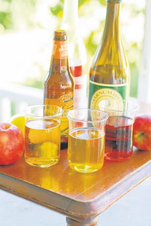 From left, glasses of hard apple cider, apple beer, and apple wine, along 
with, from left, bottles of beer, wine, and hard cider. AP