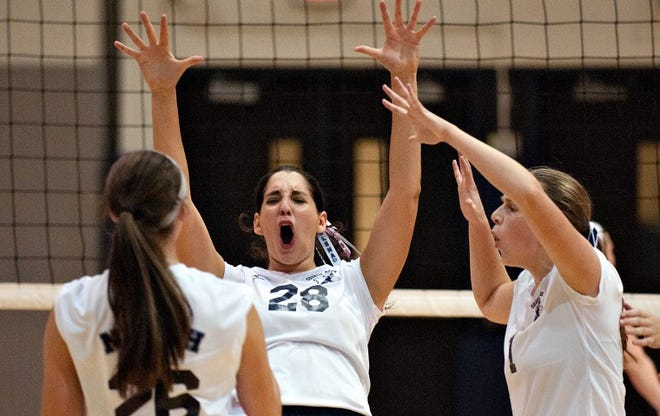 Council Rock North's Elena Flynn, center, celebrates a point in the first game of their match against Pennsbury at Council Rock North in Newtown Wednesday.