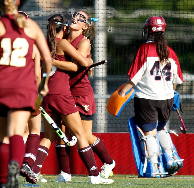Algonquin's Taylor O'Connell (facing camera) gets a hug from teammate Maggie Wraight after scoring her second goal of the game in the Tomahawks' win over Westborough.