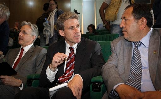 In this photo taken Monday, April 11, 2011, then U.S. envoy Chris Stevens, center, accompanied by British envoy Christopher Prentice, left, speaks to Council member for Misrata Dr. Suleiman Fortia, right, at the Tibesty Hotel where an African Union delegation was meeting with opposition leaders in Benghazi, Libya. Libyan officials say the U.S. ambassador and three other Americans have been killed in an attack on the U.S. consulate in the eastern city of Benghazi by protesters angry over a film that ridiculed Islam's Prophet Muhammad. (AP Photo/Ben Curtis)