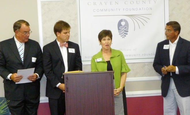 Mary Esther Baker, development officer, and Kelly Greene, regional board member of the Food Bank of Central and Eastern North Carolina, accept their funding and explain the great need to feed the hungry in Eastern North Carolina.