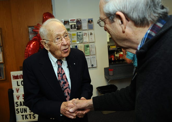 Retiring Wayland Veterans Agent John Turchinetz, left, shakes hands with Dave Smith of Wayland before a special tribute in his honor at the Wayland Senior Center Wednesday. Turchinetz, 88, and a veteran of World War II, is retiring after 13 years as the town's veterans agent.