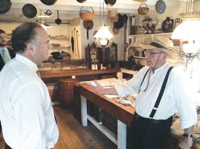 Photo by Lyndsay Cayetana Bouchal/New Jersey Herald Environmental Commissioner Bob Martin, left, listens to blacksmith store interpreter Richard Cramond, of the Canal Society of New Jersey, tell the history of Waterloo Village and the blacksmith shop.