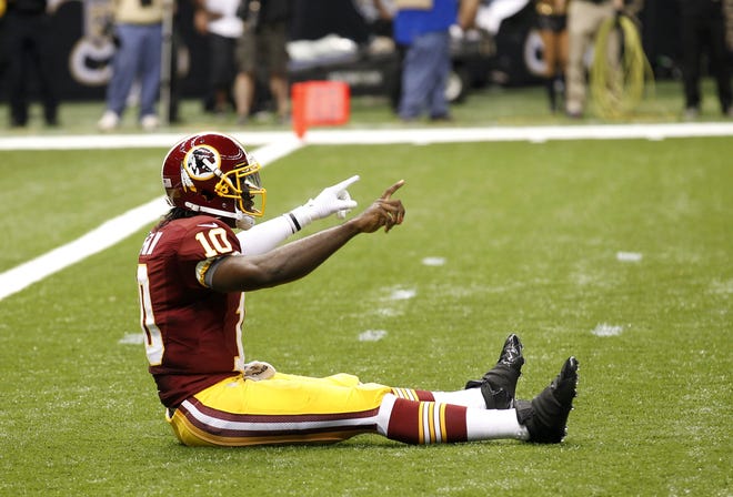 Washington Redskins quarterback Robert Griffin III (10) reacts after throwing a touchdown pass in the first quarter of an NFL football game against the New Orleans Saints at the Mercedes-Benz Superdome in New Orleans, Sunday, Sept. 9, 2012.