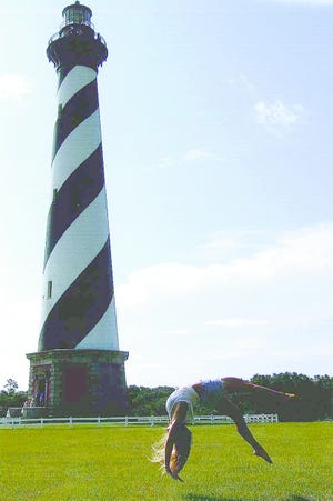 Sue Meister, who resides in Clinton, snapped this photographer of her daughter, Kaitlyn, 18, doing a backhand spring in the shadows of the Cape Hatteras National Seashore Lighthouse. Chris, Sue and Kaitlyn Meister were vacationing at the Outer Banks in North Carolina in July and were kind enough to share their adventure with our readers.