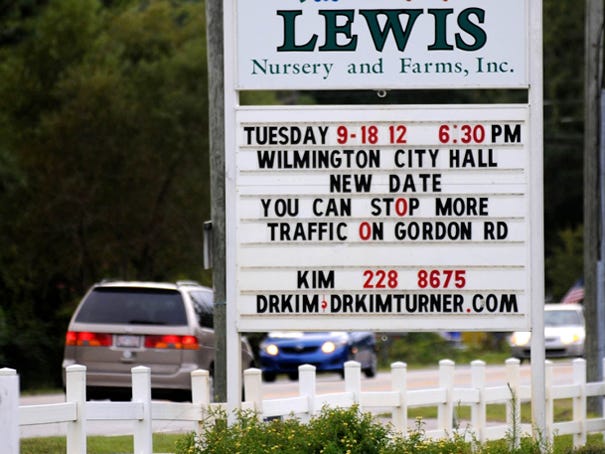 Cars pass the sign at Lewis Nursery and Farms that promotes city council's meeting on Tuesday that will discuss annexing property off Gordon Road Saturday, September 15, 2012.