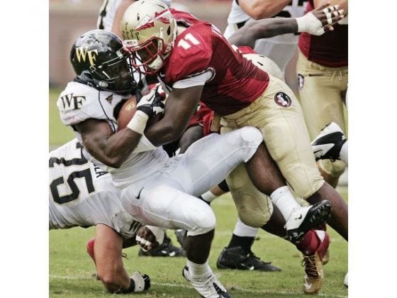 Florida State's Vince Williams stops Wake Forest's Josh Harris during the second quarter of an NCAA college football game, Saturday.