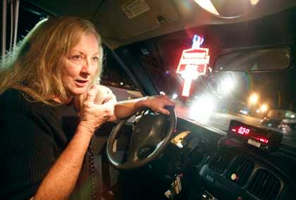 King Cab owner and driver Grace Price communicates with her base while at the Triangle in Jacksonville.