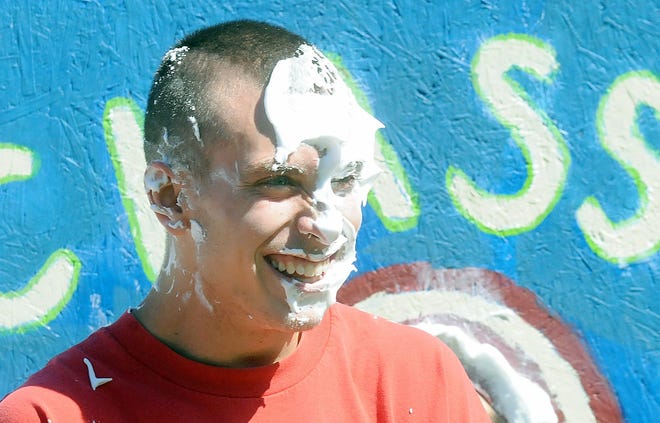 Hopedale High School senior Shane Finnegan gets hit with a pie during the annual Day in the Park on Saturday in Hopedale.