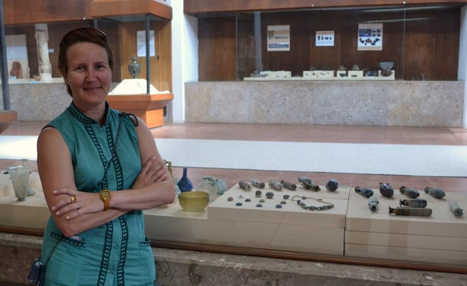 Laura C. Johnson contemplates the concept of time in front of a case of 5th century BC glass beads and artifacts near the ancient site of Troy in Turkey.