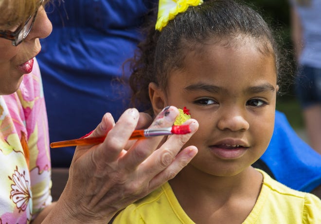 Rae-Anna Bounds, 4, gets an ice-cream cone painted on her check during the Springfield Block Party hosted by the Real Life Church at Dreamland Park, Saturday, Sept. 15, 2012, in Springfield , Ill.