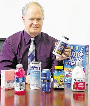 Eric Smith, sales and marketing vice president at Balchem, poses with products containing choline Friday at headquarters in New Hampton. Balchem is the world's largest producer of the nutrient.