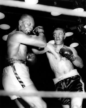 Rocky Marciano delivers a devastating right to Jersey Joe Walcott on Sept. 23, 1952, in Philadelphia in a fight which ended with a knockout in the 13th round.