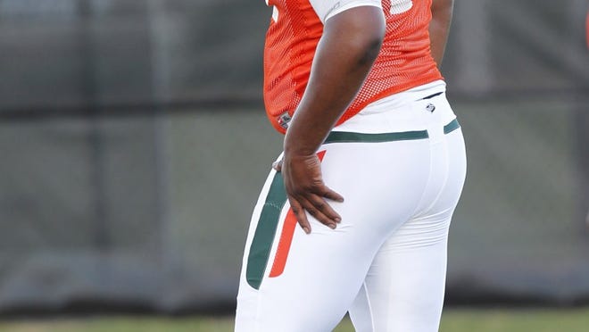 Miami offensive lineman Seantrel Henderson stretches out during practice, Thursday, Aug. 5, 2010, in Coral Gables, Fla. (AP Photo/Wilfredo Lee)