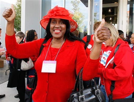 Mary Edmonds, a member of the Chicago Teachers Union's House of Delegates, celebrates after the delegates voted to suspend the strike against the school district Tuesday, Sept. 18, 2012, in Chicago. The city's teachers agreed to return to the classroom after more than a week on the picket lines, ending a spiteful stalemate with Mayor Rahm Emanuel that put teacher evaluations and job security at the center of a national debate about the future of public education. (AP Photo/Charles Rex Arbogast)