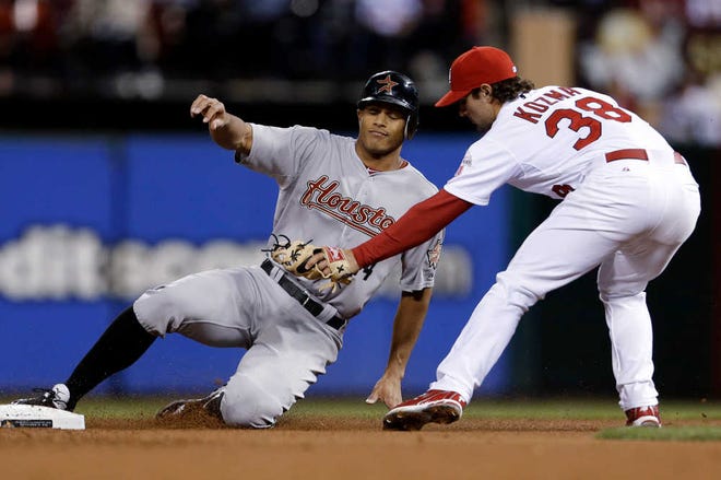 Houston's Justin Maxwell is tagged out by St. Louis shortstop Pete Kozma while trying to steal second on Tuesday in St. Louis.