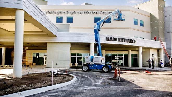 Workers put the finishing touches on the new Alan B. Miller Pavilion at Wellington Regional Medical Center, which will bring 80 private patient rooms and space for other services to the hospital.