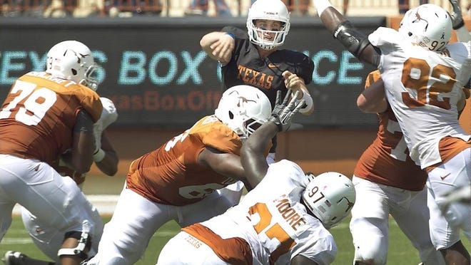 Case McCoy finds some time to throw behind his offensive line at the Longhorns' Orange-White scrimmage at Royal-Memorial Stadium on Sunday. The quarterback had a couple of great passes but also threw two interceptions.