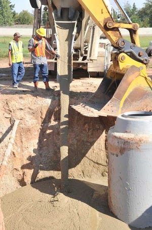The Williams Group construction crews work Thursday to replace an old brick manhole with a new fiberglass model at Interstate 40 and South Travis Street. City of Amarillo engineers estimate the brick manhole was more than 60 years old. No utility service was interrupted during the installation and crew expects the project completed by next week.