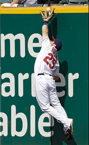 Cleveland Indians right fielder Vinny Rottino makes a leaping catch at the wall on a drive by Minnesota Twins' Chris Herrmann in the ninth inning Thursday. The Indians won 4-3.