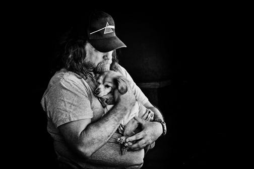 "Man Holding Dog" by artist Lowell Beyer is on view in a collection of his photography in 233 West King Gallery, 23 W. King St.