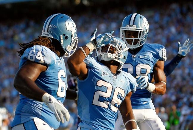 North Carolina's Giovani Bernard (26) celebrates his touchdown with teammates Jonathan Cooper (64) and Erik Highsmith (88) during their game against East Carolina in Chapel Hill on Saturday.