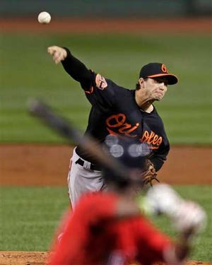 Baltimore Orioles starting pitcher Miguel Gonzalez delivers to the Boston Red Sox during the first inning of a baseball game at Fenway Park in Boston, Friday, Sept. 21, 2012. (AP Photo/Charles Krupa)