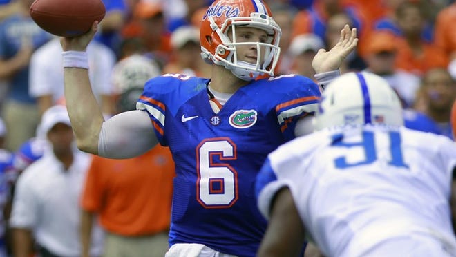 Florida quarterback Jeff Driskel (6) throws a pass as he is rushed by Kentucky defensive end Farrington Huguenin (91) during the first half of an NCAA college football game Saturday, Sept. 22, 2012, in Gainesville, Fla. Florida won 38-0. (AP Photo/John Raoux)