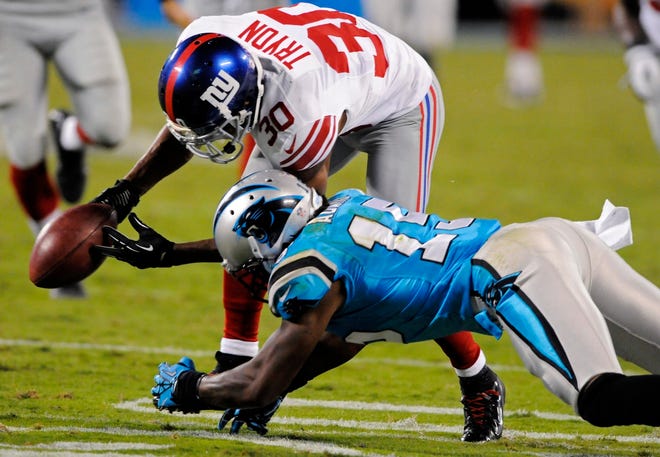 New York Giants cornerback Justin Tryon (30) recovers a fumble by Carolina 
Panthers wide receiver Joe Adams (15) during the fourth quarter in 
Charlotte, N.C. on Thursday night. The Giants won 36-7. ASSOCIATED PRESS