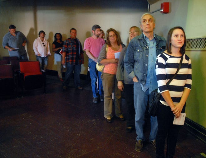 Kelli Lefler, of Thompson, and David Hopcroft, of Woodstock, wait in line for their photo to be taken during an open casting call for extras at the Bradley Play House in Putnam Friday afternoon. The casting call is for extras for an upcoming filming of a Cuba Gooding Jr. movie.