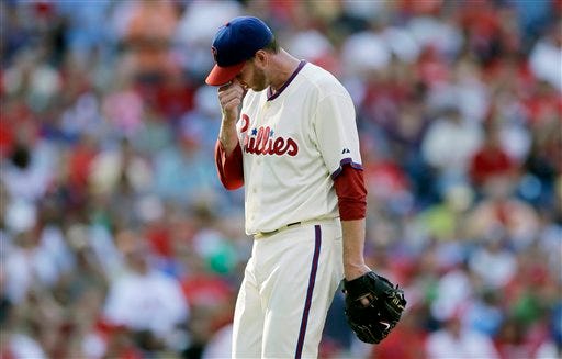 Philadelphia Phillies starting pitcher Roy Halladay wipes his face as he walks off the field after being pulled in the second inning of a baseball game against the Atlanta Braves, Saturday, Sept. 22, 2012, in Philadelphia. (AP Photo/Matt Slocum)
