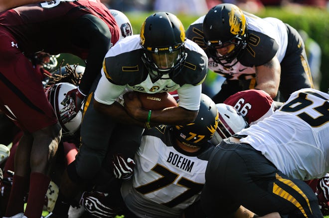 Missouri quarterback James Franklin tries to run the ball during the Tigers’ loss to South Carolina Saturday. Franklin started but was held to just 98 yards of total offense. Gary Pinkel lifted Franklin for Corbin Berkstresser with four minutes left.