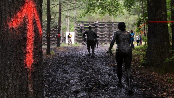 Participants tackle obstacles during the USMC Ultimate Challenge Mud Run in South Carolina, Saturday, April 21, 2012. The mud run is presented by the Greater Columbia Marine Foundation.