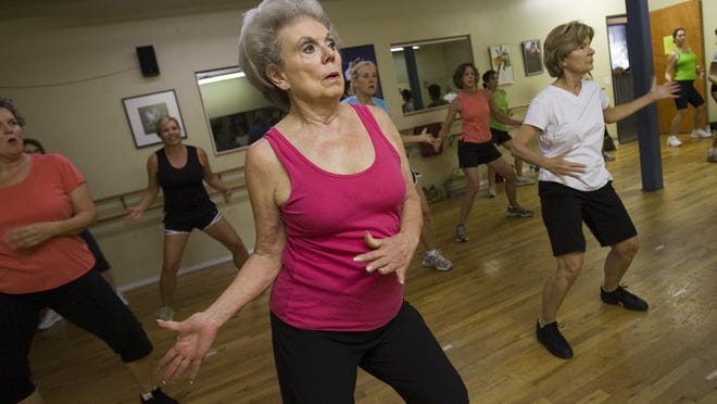 Jo Anne Christian, center, moves to the Zumba beat. The workout appeals to a broad spectrum of enthusiasts. Christian serves as chair of the Austin Lyric Opera board.