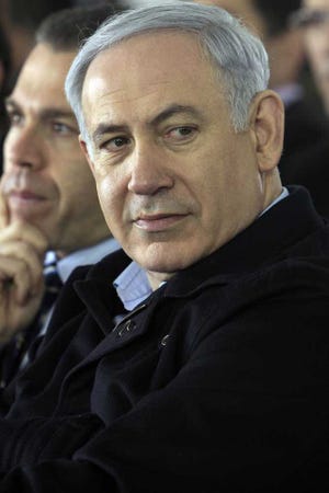 Israeli Prime Minister Benjamin Netanyahu takes part in a tree-planting ceremony for the Jewish arbor day, called 'Tu Bishvat' in Hebrew, in the southern city of Beersheba, Wednesday, Feb. 8, 2012. A former spymaster who has accused Israel's top leaders of barreling toward a rash military strike in Iran said Wednesday that Israel's survival is not at risk, an assessment that puts him sharply at odds with Prime Minister Benjamin Netanyahu. (AP Photo/Tsafrir Abayov)