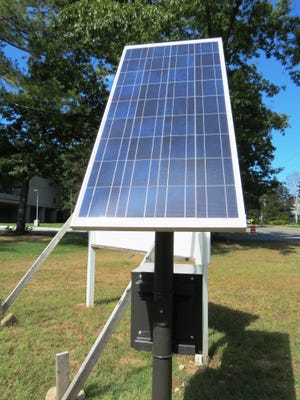 A rectangular 59-by-27 inch, 135-watt solar panel propped a pole powers an LED light that illuminates the welcome sign at Medway Middle School and display the town’s green efforts to visitors.
