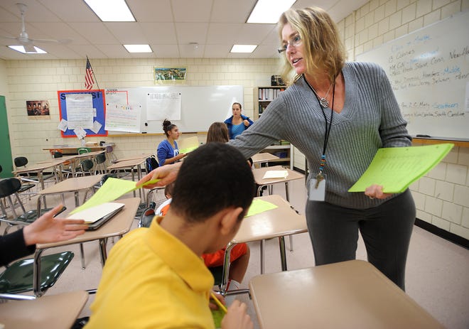 Marlborough High School teacher Shawna Stea hands out tests in her Advanced Placement U.S. history class.