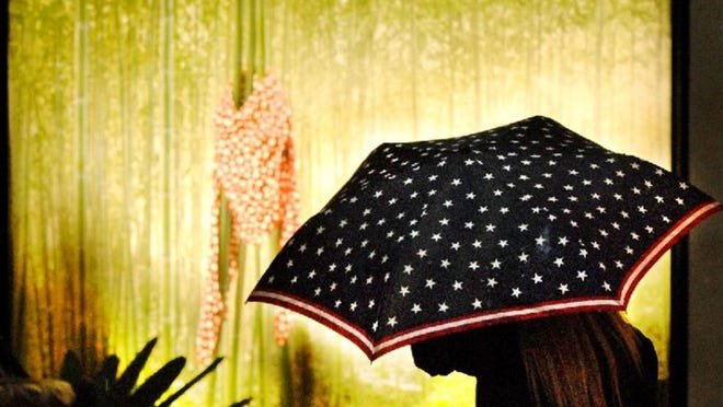 Shoppers and their umbrellas brightened 150 Worth Saturday. Daily News Photo by Melanie Bell
