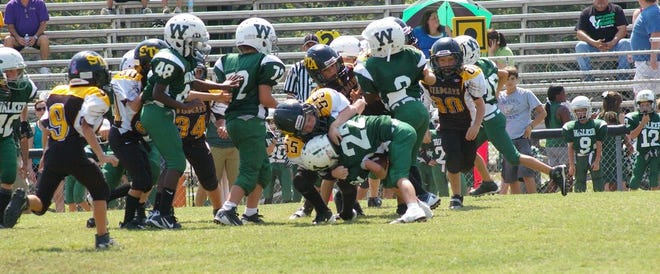 Layton Stewart of the C-Team makes a big tackle on a Wildcat runner.