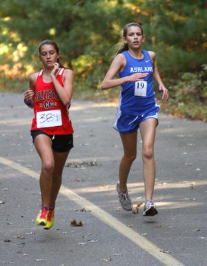 Holliston's McKinley Vrees and Ashland's Genna Heapes approach the finish line during their teams' cross country meet Monday at Ashland State Park.