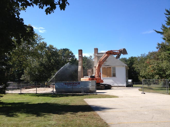Workers tear down the Curtis School building in Hanover on Monday, Sept. 24, 2012.