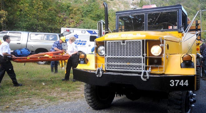 Howard Schwartz, left, and Tara King of Suburban EMS ready equipment for the rescue an injured female hiker along the Appalachian Trail near the Wolf Rocks area, a back trail located near Bangor.