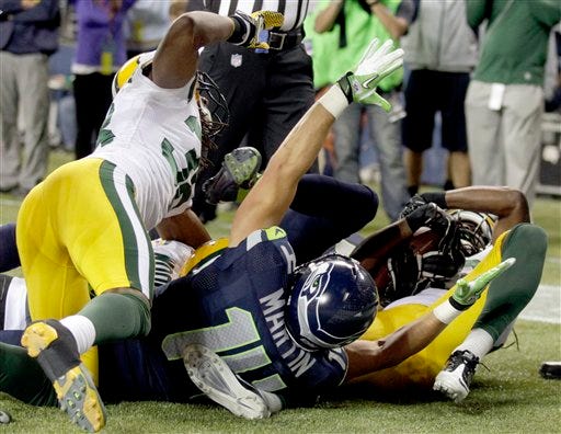 Seahawks wide receiver Charly Martin (14) celebrates a last-second touchdown by wide receiver Golden Tate against the Green Bay Packers in the fourth quarter Monday, Sept. 24, 2012, in Seattle. Seattle won 14-12.