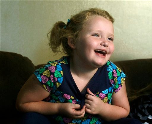In this Sept. 10, 2012 file photo, seven-year-old beauty pageant regular and reality show star Alana "Honey Boo Boo" Thompson gestures during an interview in her home in McIntyre, Ga. The TLC network said Wednesday that it has ordered Halloween, Thanksgiving and Christmas specials focusing on its seven-year-old breakout star Honey Boo Boo. The series airs its 10th and final episode of its debut season on Wednesday, Sept. 26. (AP Photo/John Bazemore)