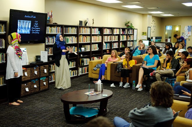 From left, Farah El-Jayyousi and Arwa Mohammad speak during a “Women in Islam” program Tuesday at the University of Missouri Women’s Center. They talked about basic principles of the religion and women’s role in Islam.