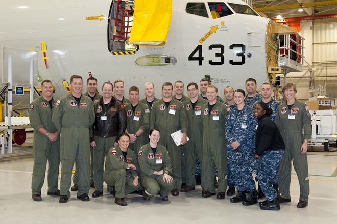 Members of the VP-16 "War Eagles" gather in front of a new P-8A Poseidon aircraft currently being built at The Boeing Company in Renton, Wash. Sept. 14. The group travelled to Washington to tour Boeing facilities and to learn more about the new aircraft the squadron is flying.