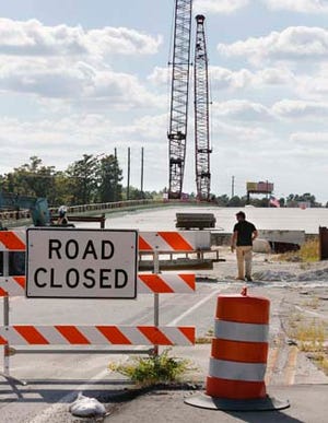 Construction on the Herbert G. "Buddy" Phillips Bridge, over the New River in Jacksonville, has slowed down due to the contractor filing bankruptcy but will not stop.